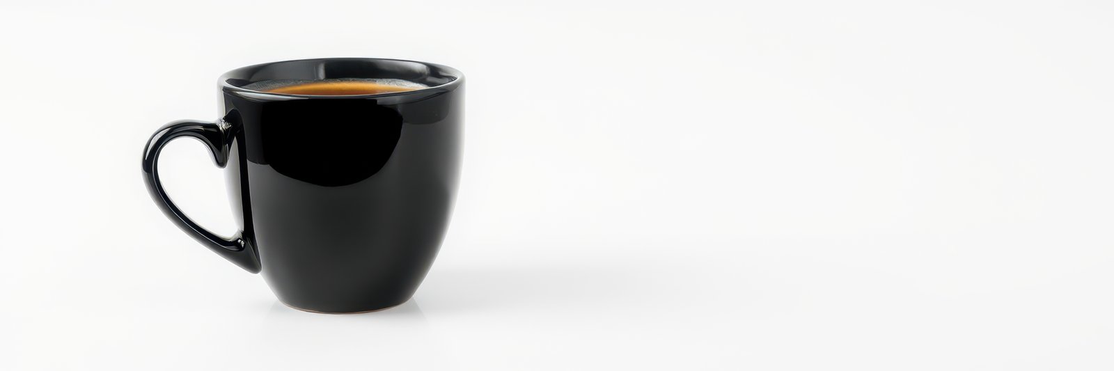 Freshly brewed coffee in a sleek black cup on a minimalistic table in a bright setting
